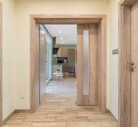 Hallway in a family house with wooden doors and translucent panels.