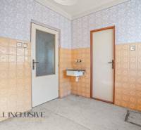 Interior with a sink, tiles, and doors in a family house.