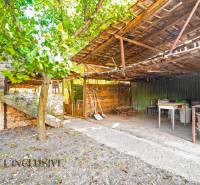 Outside a family house in the village of Veľká Mača, there is a gazebo with a wooden roof.