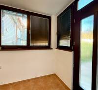 The interior of a family house with dark window frames and blinds on the windows.