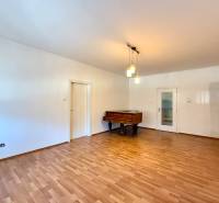 Living room in a family house with a piano and a wooden decor floor.