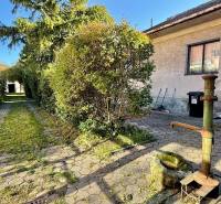 A family house on Prostredná Street in Svätý Jur with a courtyard and a well in the garden.