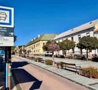 Bus stop in Svätý Jur on the Square with surrounding pedestrian zone and historical buildings.