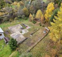 Plots - living in Bacúch with a house, trees, and a concrete area. Autumn scenery.