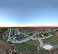 Panoramic view of residential plots around Voderady, with a view of the fields.