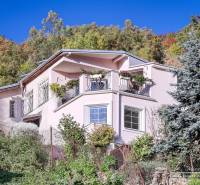 A family house in Bratislava - Devín with a balcony, floral decorations, and a lush garden.