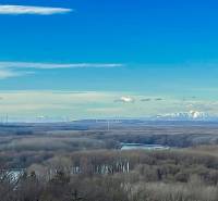 View of wind turbines and snowy peaks from a cottage in Bratislava - Devín.