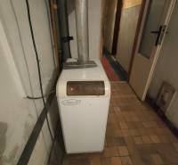 Heating in a boiler room in a family house with a floor with a wooden decor.