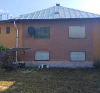 A family house in Divinka on Lalinek with a brown facade, satellite, and a shelter.
