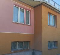 A family house on Lalinok Street in Divinka with a colorful facade and railing on the roof.