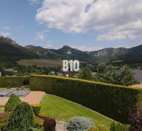 View from the villa in Súľov-Hradná of the hilly landscape and greenery in the garden.