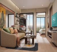 Interior of a 2-room apartment with a wood-patterned floor, a comfortable sofa, and a balcony.
