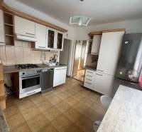 A kitchen in a 3-room apartment with a kitchen unit and built-in appliances.