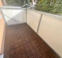 Balcony in a 3-room apartment on Majakovského Street in Lučenec, floor with wooden decor.