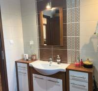 Bathroom sink with mirror in a 2-room apartment, ceramic tiles with ornaments.
