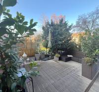 Terrace of a 2-room apartment in Bratislava - Ružinov with greenery and garden furniture.