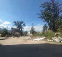 Podbreziny Háje Street in Liptovský Mikuláš, plots - residential, trees, and containers.
