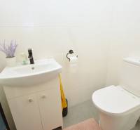 Bathroom in a 3-room apartment with white tiles and a stylish sink.