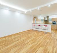 Spacious kitchen in a 3-room apartment with an island and a wooden decor floor.
