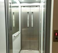 Elevator cabin with metal doors and energy-saving LED lights.