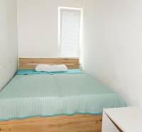 Bedroom in a 3-room apartment with a bed and a white dresser.