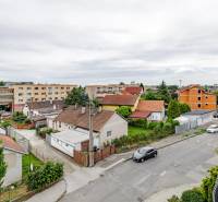Pri strelnici Street in Ružinov, Bratislava with family houses and greenery.