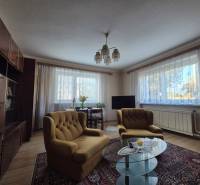 Living room in a family house with comfortable seating, floor with wooden decor.