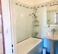 A bathroom with a shower and a sink in a 4-room apartment.