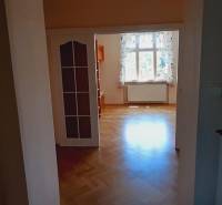 A room with a light window and a floor with a wooden decor, 4-room apartment.