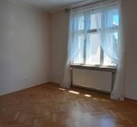 A room in a 4-room apartment with a wooden decor floor and a large window.