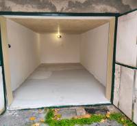 An open garage with white walls and simple lighting in Detva on M. R. Štefánika Street.