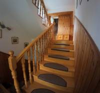A staircase in a family house with wooden decor and decorations on the walls.