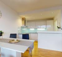 Interior of a 2-room apartment with a kitchenette and a floor with a wooden decor.