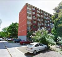Apartment building on A. Hlinka Street in Piešťany, surrounded by greenery and parked cars.