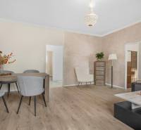 Bright living room with seating and wooden furniture in a 3-room apartment.