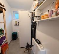 Storage space of a family house with a shelf, a bookshelf, and various goods.