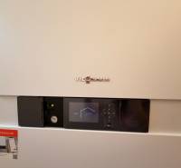 Viessmann brand condensing boiler with a digital display in a family house.