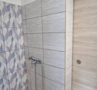Bathroom in a 2-room apartment with modern tiles and a shower corner.