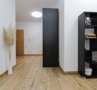 Wooden decor flooring, shelf, and decorative grass in a 2-room apartment.