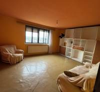 Living room in a family house with sofas and built-in storage cabinets.