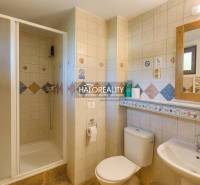 A cottage in Liptovský Mikuláš with wooden furniture on the terrace and a garden.