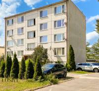 A four-story apartment building with trees and cars on Stummerova Street in Topoľčany.