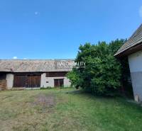 A family house in Zvolen with a yard, shelter, and trees, ideal for country-style living.