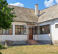 A family house in Zvolen with a white facade, wooden windows, and a gable roof.