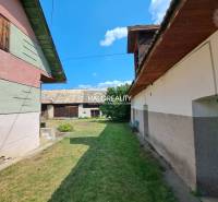 A family house in Zvolen with courtyards, a grassy garden, and extensions.