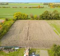 Extensive arable lands in Blahová surrounded by greenery and trees for living.