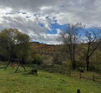 Autumn landscape from the cabin in Píla with a swing on the green meadow.