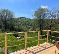 A terrace at a cottage in Píla with a view of the green landscape and a swing.