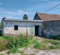 A yard with abandoned buildings and an old fence on Štúrova Street, suitable for a family house.