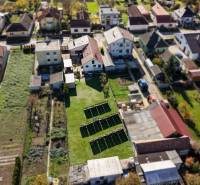 A top-down view of family houses on Južná Street in Veľké Orvište with gardens.